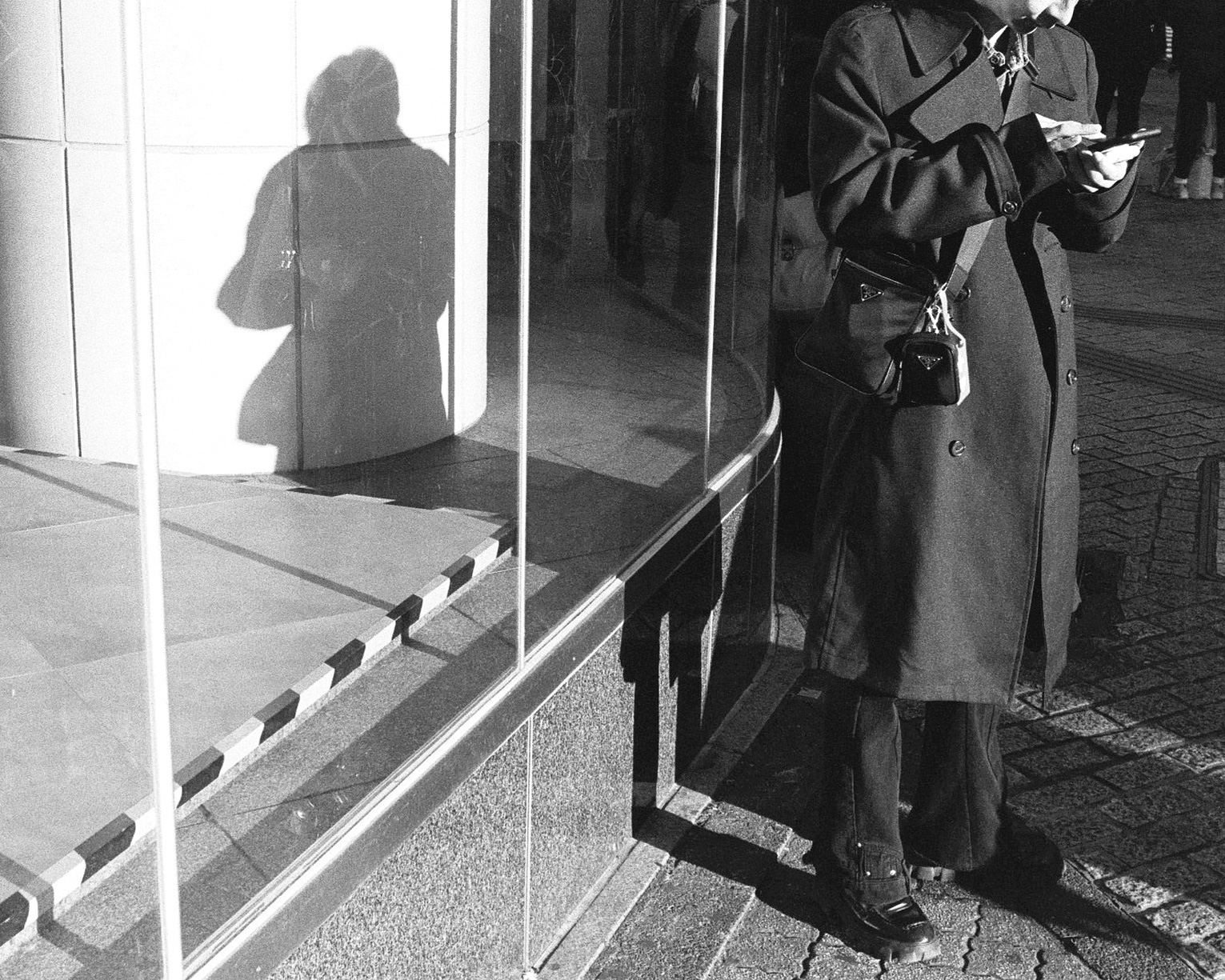A restrained study of urban surface, reflection, and passing street light.