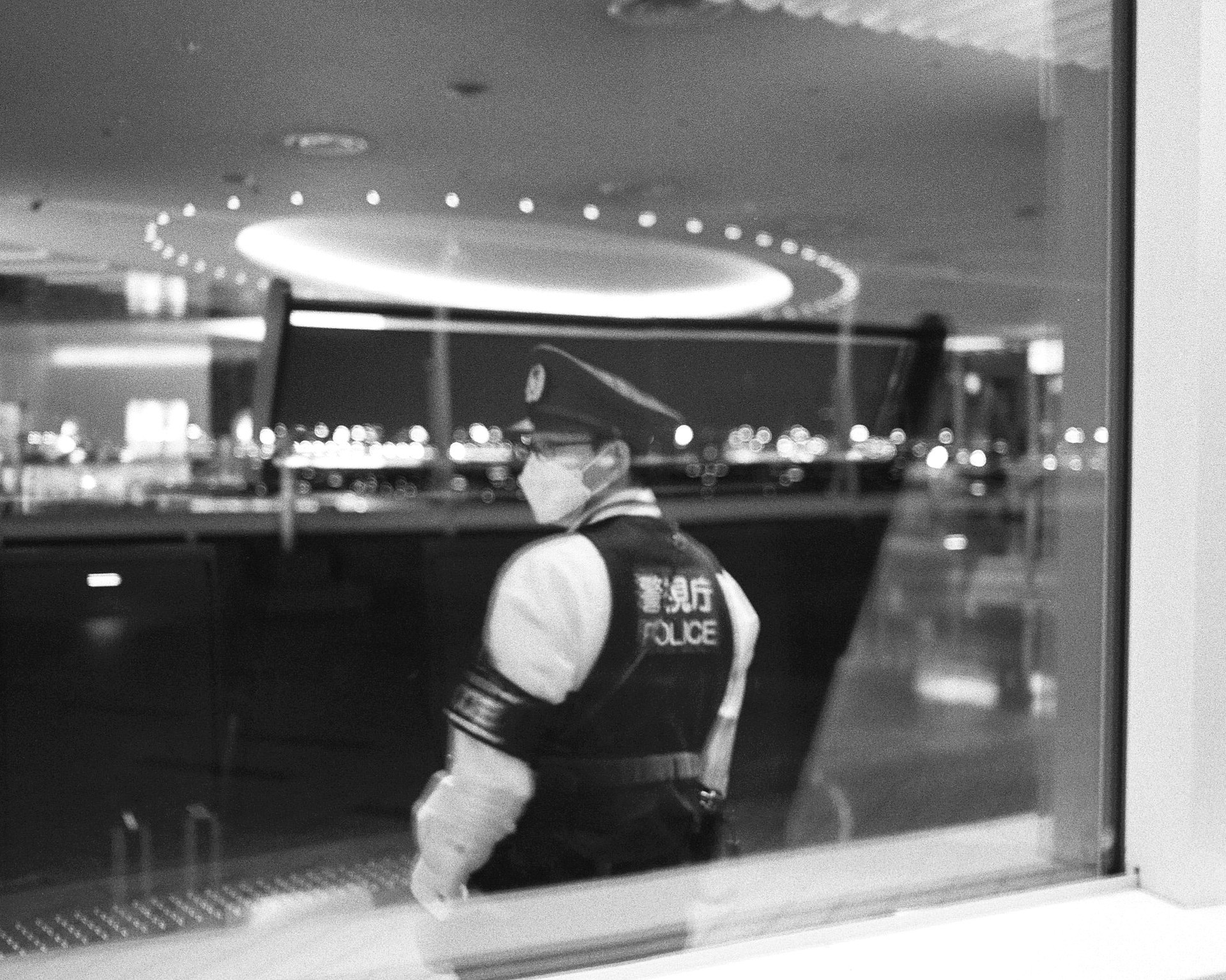 Plastic curtains and city light creating a soft barrier between viewer and street.